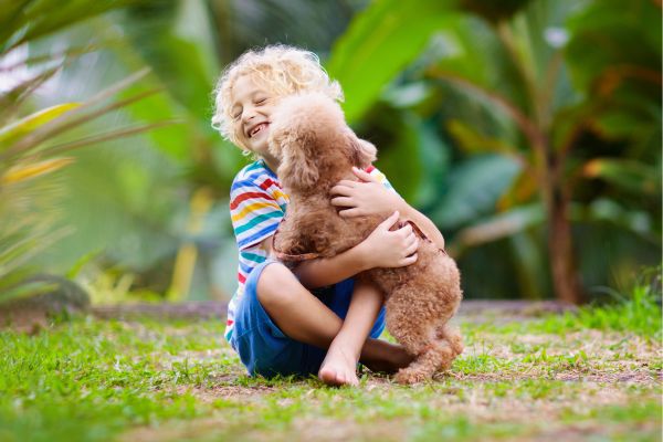 kid and puppy playing