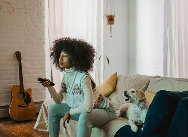 Woman and her dog watching TV